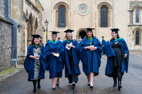 A group of graduates outside Norwich Cathedral