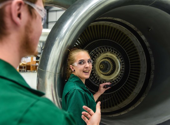 Female student working on aircraft engine at the International Aviation Academy Norwich