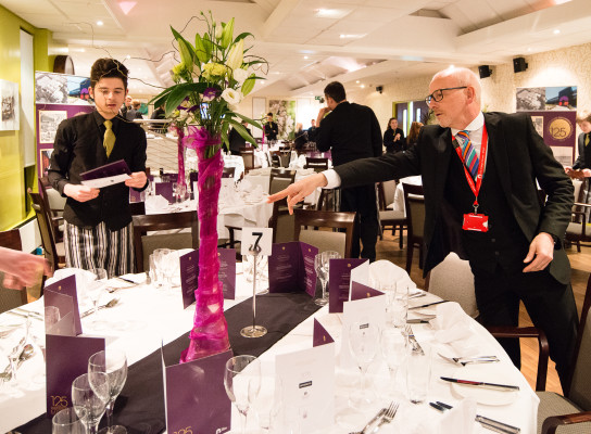 Alan George working with a student in Debut Restaurant at the city college norwich 125th anniversary dinner