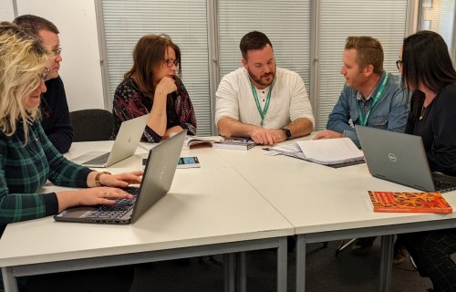 Staff having a meeting around a table
