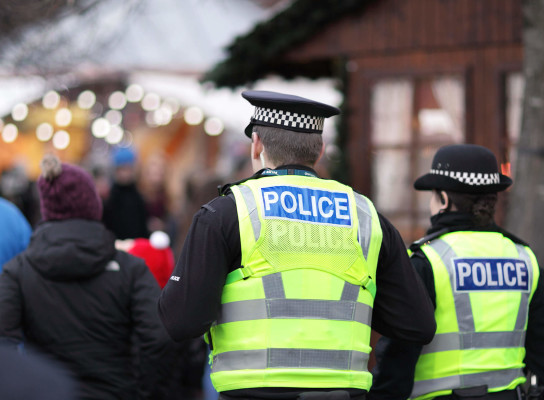 Police officers walking amongst crowd