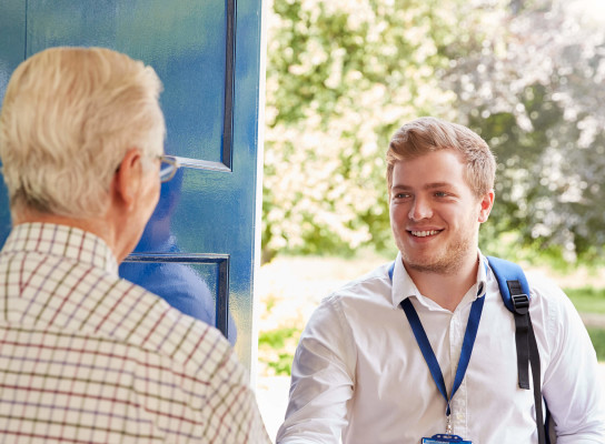 Young man and elderly man shaking hands