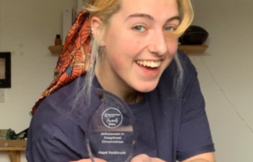 Student holding their award