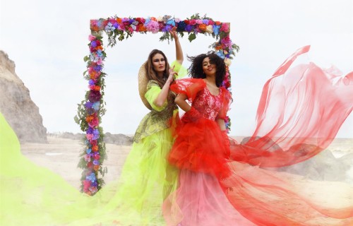 Two models walk under an arch at a fashion shoot at Happisburgh beach