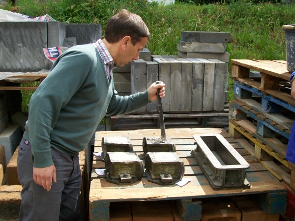 Brian making concrete test cubes and test beams after a mixer lorry demonstration near the brickwork workhop in 2008.