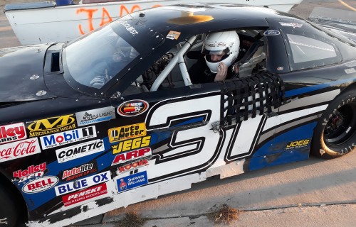 Student Keenan Tully sitting in a race car