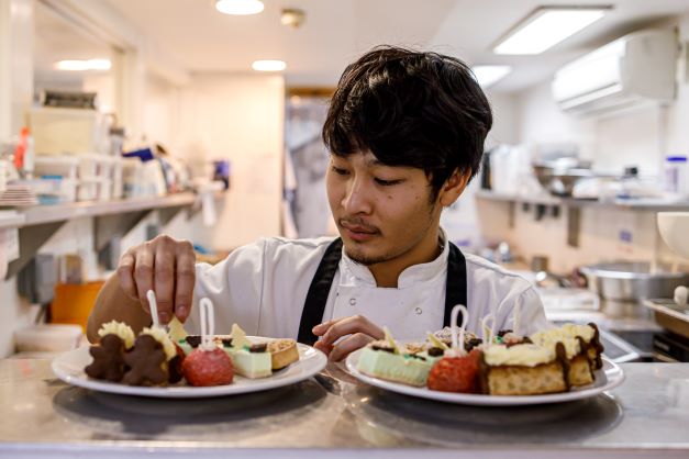 Student Patsakorn Thitisap working at the Great Fosters hotel in Surrey