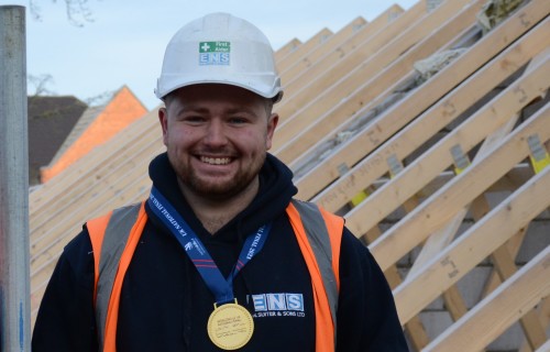 Construction student on a building site where a house is being built