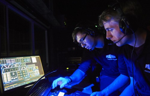 Production arts students working on a computer