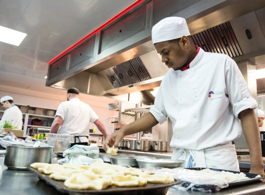 Hospitality and catering students working in a professional kitchen