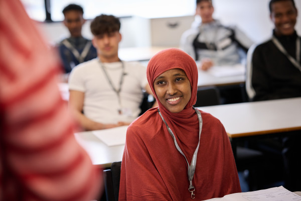 Smiling EMSOL student sat at her desk